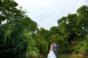 Bride and groom in front of trees 