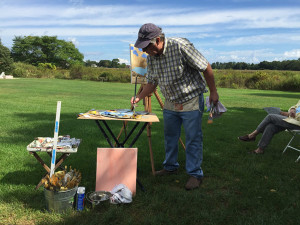 Max Moran painting outside at Jedediah Hawkins Inn for an art class Moran